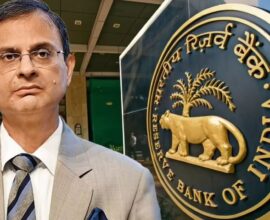 RBI Governor Sanjay Malhotra standing, with the Reserve Bank of India logo visible on the other side.