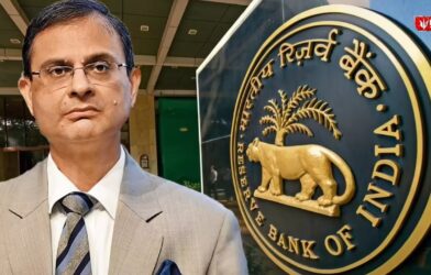 RBI Governor Sanjay Malhotra standing, with the Reserve Bank of India logo visible on the other side.