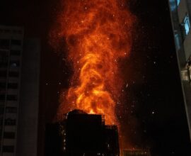 Massive fire in Hong Kong multistorey buildings with smoke and rescue operations in progress