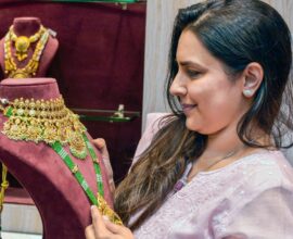 Woman checking gold jewellery at a shop