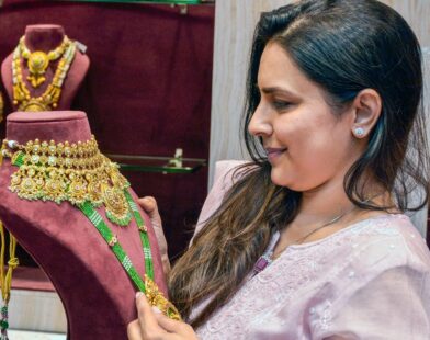 Woman checking gold jewellery at a shop