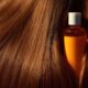 Mustard oil bottle partially hidden inside long hair