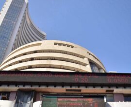 Stock market candlestick chart showing Sensex up with a strong green surge and traders monitoring screens