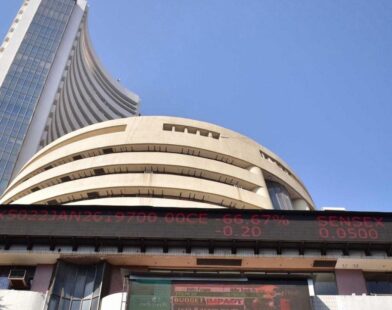 Stock market candlestick chart showing Sensex up with a strong green surge and traders monitoring screens