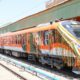 Vande Bharat sleeper train standing at the railway station with passengers and staff near the platform