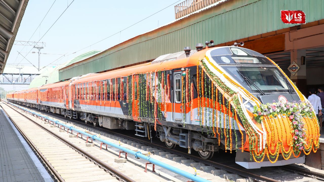 Vande Bharat sleeper train standing at the railway station with passengers and staff near the platform