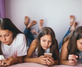 Illustration showing a smartphone with a “No Social Media under 16” sign, representing Australia’s ban on social media for children below 16 years