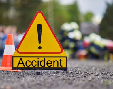 Scene of a serious road accident on the Dhule–Solapur Highway showing damaged vehicles, with reports of one person dead and another critically injured