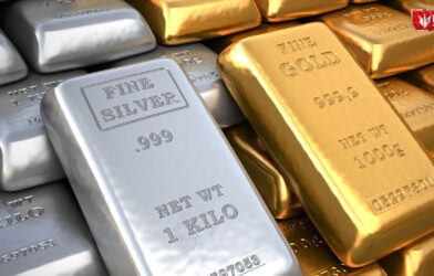 Gold bars and silver coins representing rising gold prices and falling silver rates due to expected interest rate cuts