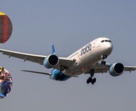 IndiGo aircraft grounded at the airport with large crowds of stranded passengers due to mass flight cancellations