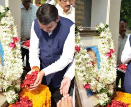 Devendra Fadnavis paying tribute to Dr. Babasaheb Ambedkar by offering flowers and garlanding his photo during a memorial event