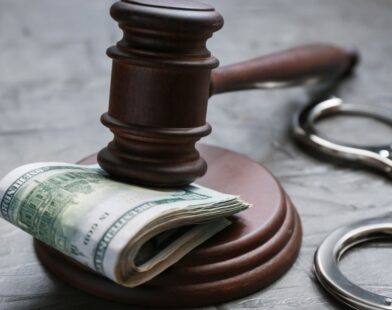 Anti-Corruption Bureau officers in Pune detaining two suspects in an ₹8 crore bribe case