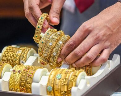 Silver bars and gold coins representing the latest record-breaking price surge