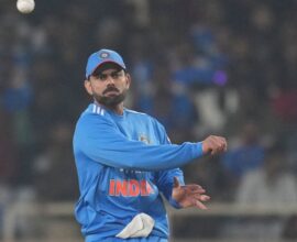 Virat Kohli standing on the cricket ground after India’s victory against South Africa, looking confident