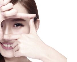 Woman applying eye cream during winter for dry eye prevention and healthy eyes