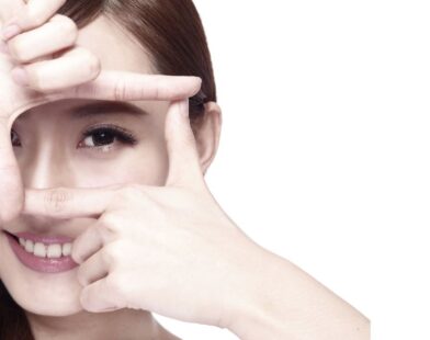 Woman applying eye cream during winter for dry eye prevention and healthy eyes